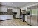 Updated kitchen features white cabinets, stainless steel appliances, and modern backsplash at 4090 Mark Todd Ct, Hoschton, GA 30548