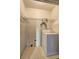 The laundry room features tile flooring, overhead shelving, and a washing machine at 4090 Mark Todd Ct, Hoschton, GA 30548