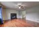The living room with wood flooring features a cozy fireplace at 4090 Mark Todd Ct, Hoschton, GA 30548