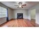 Inviting living room showcasing wood flooring and a striking black fireplace at 4090 Mark Todd Ct, Hoschton, GA 30548
