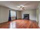 Spacious living room featuring sleek hardwood floors, and a cozy fireplace at 4090 Mark Todd Ct, Hoschton, GA 30548