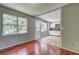 Spacious living room with hardwood floors, a beam and access to kitchen at 4090 Mark Todd Ct, Hoschton, GA 30548