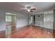 Open-concept living room boasting gleaming hardwood floors and modern gray walls at 4090 Mark Todd Ct, Hoschton, GA 30548