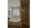 Bright bathroom featuring a soaking tub, separate shower, and modern fixtures at 4261 Notting Hill Sw Dr, Atlanta, GA 30331