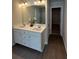 Bathroom with a double sink vanity, a large mirror, and tile floors at 4261 Notting Hill Sw Dr, Atlanta, GA 30331