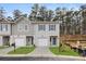 New construction townhomes displaying landscaped yards, driveways, and individual garages at 4261 Notting Hill Sw Dr, Atlanta, GA 30331