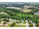 Wide aerial shot showcasing a neighborhood with green spaces, homes, and nearby community areas at 7434 Chads Cir, Jonesboro, GA 30236