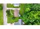 Aerial view of a home with a well-maintained lawn, mature trees, and a paved driveway at 7434 Chads Cir, Jonesboro, GA 30236