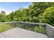 View from a gray back deck overlooking a green lush landscape and clear blue skies at 7434 Chads Cir, Jonesboro, GA 30236