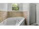 Bathroom featuring a bathtub and a shower at 7434 Chads Cir, Jonesboro, GA 30236