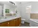 Bright bathroom featuring double sinks, a garden tub, and a separate shower at 7434 Chads Cir, Jonesboro, GA 30236
