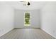 Empty room with a large window and hardwood floors at 7434 Chads Cir, Jonesboro, GA 30236
