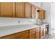Classic kitchen featuring wood cabinets, light countertops, and a stainless steel sink at 7434 Chads Cir, Jonesboro, GA 30236