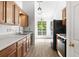 Well-lit kitchen boasts stainless steel appliances, wood cabinets, and a light-colored countertop at 7434 Chads Cir, Jonesboro, GA 30236