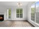 Bright living room featuring a cozy fireplace, large windows, and hardwood flooring at 7434 Chads Cir, Jonesboro, GA 30236