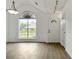 Bright room featuring new floors, a large window, a door, and fresh white walls at 7434 Chads Cir, Jonesboro, GA 30236