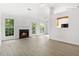 Bright living room featuring a cozy fireplace, large windows, and hardwood flooring at 7434 Chads Cir, Jonesboro, GA 30236