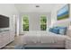 Bright main bedroom with a king bed, modern decor, and lots of natural light from two windows at 7434 Chads Cir, Jonesboro, GA 30236
