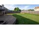 Spacious backyard with a brick-paved patio, grassy area, and wooden fence perfect for entertaining at 9120 Alden Dr, Locust Grove, GA 30248
