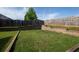 Grassy backyard with wooden fence, retaining wall, and ample space for recreation and outdoor activities at 9120 Alden Dr, Locust Grove, GA 30248