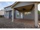 Backyard covered patio with ceiling fan, brick-paved patio, and exterior view of the home at 9120 Alden Dr, Locust Grove, GA 30248