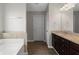 Elegant bathroom with double vanity, granite countertops, and a separate soaking tub at 9120 Alden Dr, Locust Grove, GA 30248