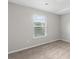 A sunlit bedroom with soft, neutral carpet and a large window at 9120 Alden Dr, Locust Grove, GA 30248