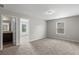 Comfortable bedroom featuring plush carpeting and easy access to the on-suite bathroom at 9120 Alden Dr, Locust Grove, GA 30248