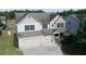 Attractive two-story home with a two-car garage and well-maintained landscaping at 9120 Alden Dr, Locust Grove, GA 30248