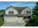Charming two-story home with a two-car garage and beautifully manicured lawn at 9120 Alden Dr, Locust Grove, GA 30248