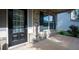 Charming front porch with brick facade and dark wood door featuring glass panes and a black door knob at 9120 Alden Dr, Locust Grove, GA 30248