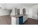 Kitchen island with granite counters, sink, dishwasher, and stylish pendant lighting at 9120 Alden Dr, Locust Grove, GA 30248