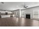 Open-concept living room featuring a fireplace, and an island kitchen with white cabinets at 9120 Alden Dr, Locust Grove, GA 30248