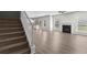 Open-concept living area with hardwood floors, fireplace, and natural light at 9120 Alden Dr, Locust Grove, GA 30248