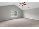 Spacious primary bedroom with plush carpeting, vaulted ceilings, and a ceiling fan at 9120 Alden Dr, Locust Grove, GA 30248