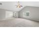Large primary bedroom with plush carpeting, neutral paint, and ample natural light at 9120 Alden Dr, Locust Grove, GA 30248
