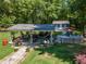 Shaded backyard with patio and outdoor grilling area, with small storage shed at 100 Chadwick Pl, Villa Rica, GA 30180