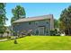 Exterior of home with a manicured backyard, lush lawn, and mature trees at 100 Chadwick Pl, Villa Rica, GA 30180