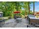 Outdoor patio with an umbrella, grill, and ample seating area at 100 Chadwick Pl, Villa Rica, GA 30180