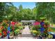 Backyard with lush landscaping, red flowers, and a charming gazebo at 100 Chadwick Pl, Villa Rica, GA 30180