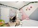 Bright bedroom with pastel decorations, featuring a ceiling fan and lots of natural light at 100 Chadwick Pl, Villa Rica, GA 30180