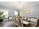 Bright dining room with chandelier, dining table set for eight, and white wainscoting at 100 Chadwick Pl, Villa Rica, GA 30180