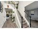Welcoming entryway with staircase, wood floors, and view of kitchen and living room at 100 Chadwick Pl, Villa Rica, GA 30180