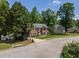 Two story brick home with lush front lawn near the neighborhood entrance sign at 100 Chadwick Pl, Villa Rica, GA 30180