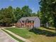 Two story brick home with gray siding, well maintained lawn, and mature trees at 100 Chadwick Pl, Villa Rica, GA 30180