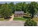 Well maintained two story brick home featuring a manicured lawn and mature landscaping at 100 Chadwick Pl, Villa Rica, GA 30180
