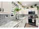 A modern kitchen with white cabinets, stainless steel appliances, and granite countertops at 100 Chadwick Pl, Villa Rica, GA 30180