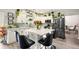 This kitchen has a center island with seating, white cabinets, modern appliances, and elegant decor at 100 Chadwick Pl, Villa Rica, GA 30180