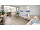 Open-concept living and dining area with stylish decor and hardwood floors at 100 Chadwick Pl, Villa Rica, GA 30180
