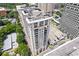 Aerial view of a luxury high-rise condo building with balconies and surrounding cityscape at 3040 Peachtree Nw Rd # 1803, Atlanta, GA 30305